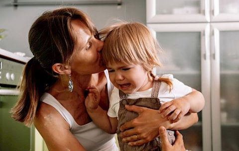 Young,Mother,Tries,To,Calm,Her,Crying,Little,Daughter.,Raising
