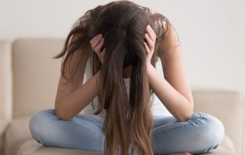 Depressed,Teenager,Sitting,Holding,Head,In,Hands,,Stressed,Sad,Young
