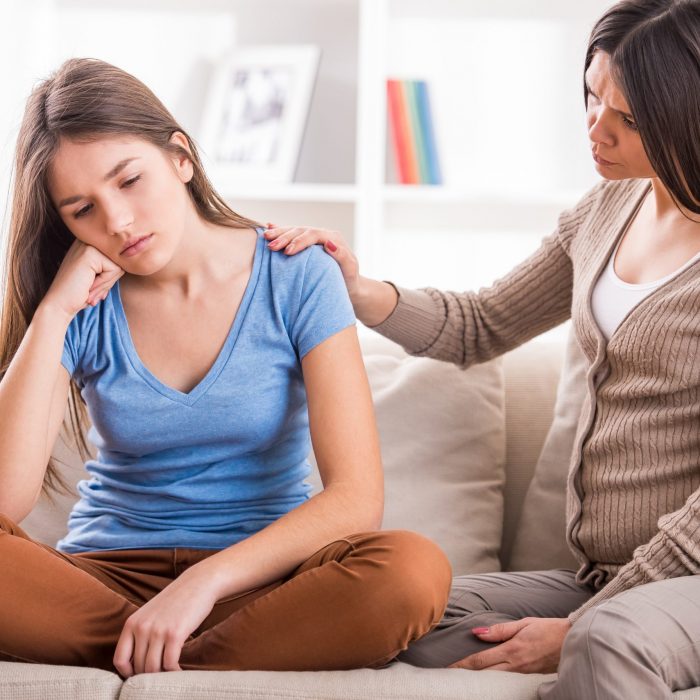 Mother,And,Teen,Daughter,After,Quarrel,On,Sofa,At,Home.