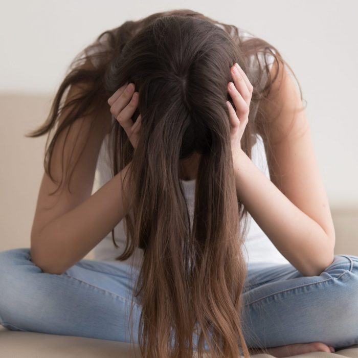 Depressed,Teenager,Sitting,Holding,Head,In,Hands,,Stressed,Sad,Young